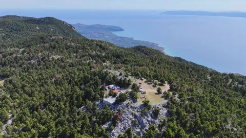 Mountain ridge chapel above forest with sea view, Greece aerial Stock-Footage 333245673