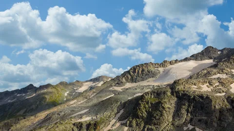 Mountain ridge with glacier in dense clouds time lapse scene Stock Footage 248038857