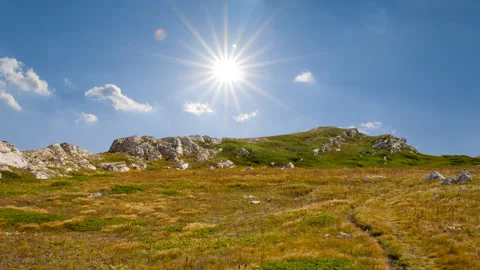 Mountain ridge with grass under a sparkle sun Stock Footage 311874173