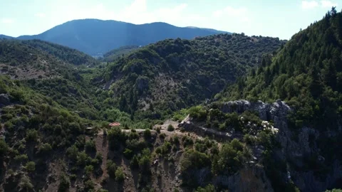 Mountain ridge landscape with small pavilion surrounded by dense green forest Stock Footage 344095792