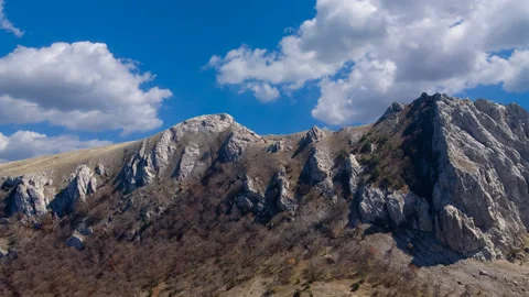 Mountain ridge under blue cloudy sky, outdoor travel time lapse scene Stock Footage 165348244