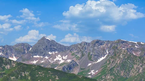 Mountain ridge under a blue cloudy sky 库存影片 339656374