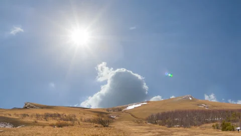 Mountain ridge under cloudy sky at sunny day Stock Footage 257606027
