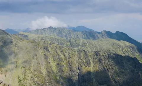 Mountain ridge under a dense cloudy sky Stock Photos