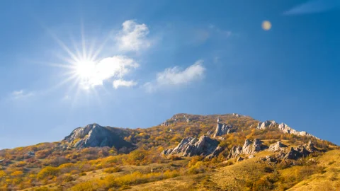 Mountain ridge under a sparkle sun, mountain travel time lapse scene Stock Footage 147484039