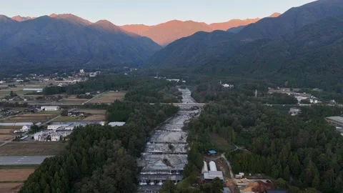 Mountain Ridge with Warm Highlights Beyond a Valley River 库存影片 347489997