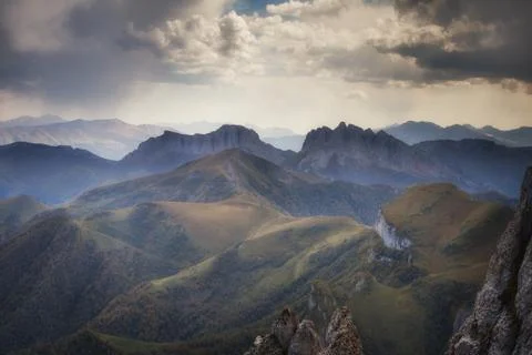 Mountain ridges at against the sky with clouds Stock Photos