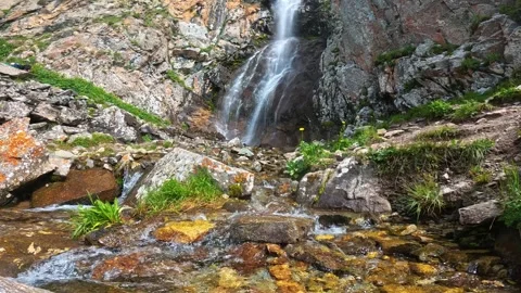 Mountain river against the backdrop of a waterfall 스톡 동영상 282349429