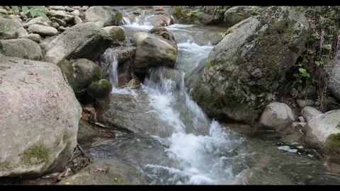 Mountain river against the background of stones. Cool waterfall on trekking in Stock Footage 346119351