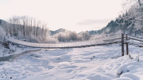 Mountain river and bridge covered with snow Stock Footage 123462727