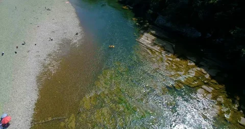 Mountain river and stone thresholds. people rest on the shore and on an Stock Footage 98247624