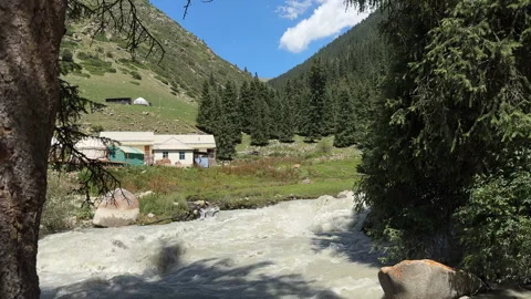 Mountain river and yurts in Jeti-Oguz, Kyrgyzstan, 4K Stock Footage 342030821