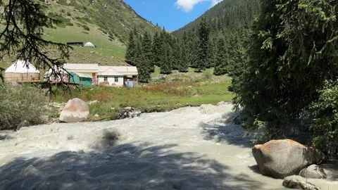Mountain river and yurts in Jeti-Oguz, Kyrgyzstan, 4K Stock Footage 342031475