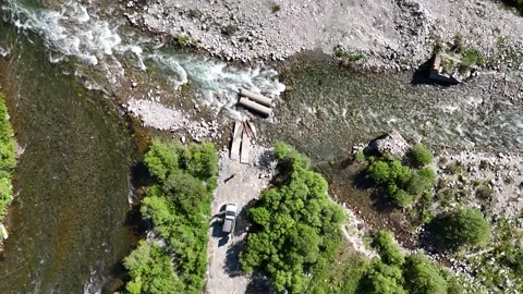 Mountain River with Broken Crossing and Stuck Car on Old Austrian Road, East Stock Footage 317511816