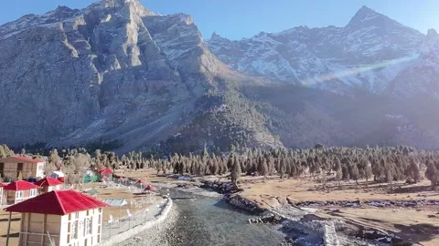 Mountain River with Cabins Under Snow-Capped Peaks. Stock Footage 322787352