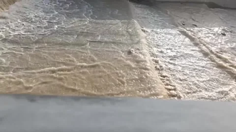 Mountain river in concrete channel with muddy water 库存影片 335952595