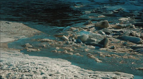 Mountain river with cracked blocks of ice and floes in sunny spring afternoon Stock Footage 36846706