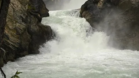 Mountain river crashing over through the rocks in a dramatic waterfall.  Stock Footage 146873621