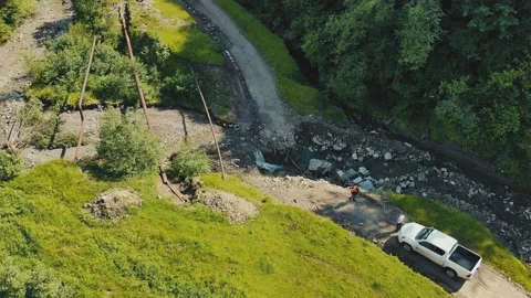 A mountain river that destroyed the road. A car that cannot pass on a road Video stock 135169328