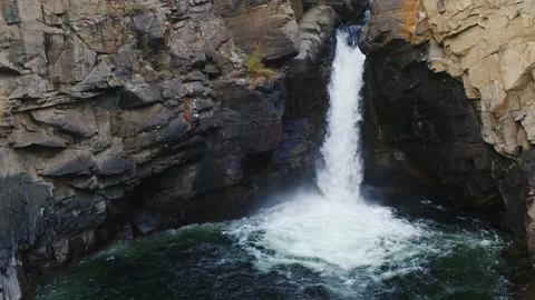 Mountain river falls in gorge. Waterfall flows down from cliff Video stock 238837591