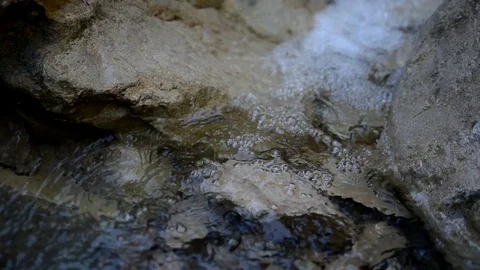 Mountain river falls on the stones. Bubbles on the water. Wild flow. Stock Footage 97712136
