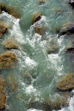 Mountain river flow between rocks top view macro texture Stock Photos
