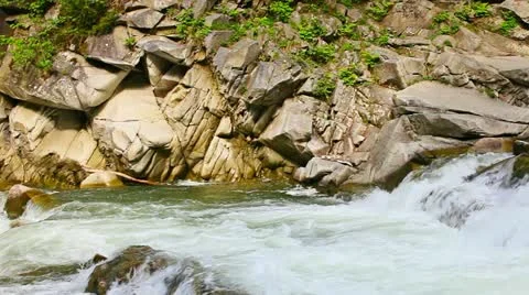 Mountain river flowing around rocks Stockbeeldmateriaal 11490931