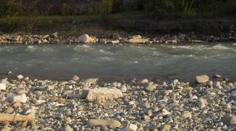 Mountain river flowing between stones and trees, bank, wide angle Stock Photos