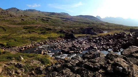 Mountain river flowing from Gufufoss waterfall in East Iceland Stock Footage 333915539