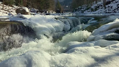 Mountain river flowing strongly through snowy winter landscape Video stock 342621918