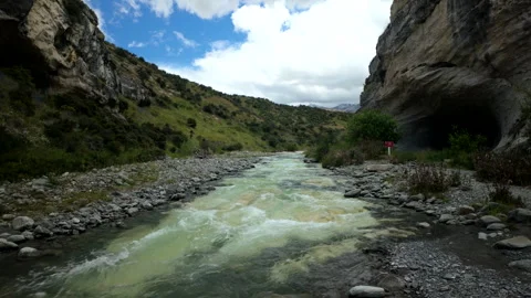 Mountain River Flowing Through Rocky Gorge Under Dramatic Sky Stock Footage 327067416