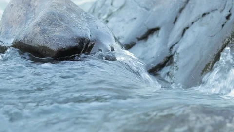 Mountain river flowing through stone boulders Stock Footage 248773309