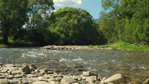 Mountain river flowing through stone boulders. Clear water stream Stock Footage 254556086