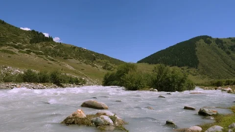 Mountain river flowing in valley on background highlands and green fields Video stock 94267955