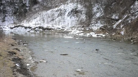 Mountain river flowing in winter with white snow on river banks Stock Footage 54362628
