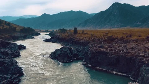 A mountain river flows among the rocks and boil with its lush waters 動画素材 115252001