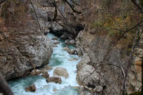 The mountain river flows among the rocks. Stock Photos