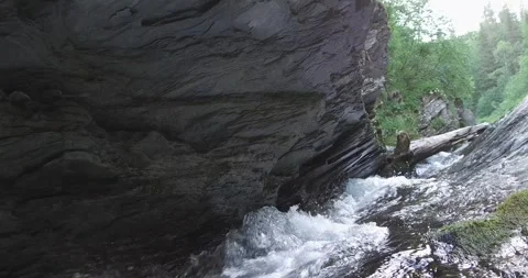 Mountain river flows below the big rock. Ural Mountains Stock Footage 269539944