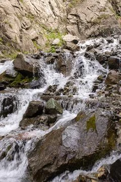 Mountain river flows fast over rocks close-up Stock Photos