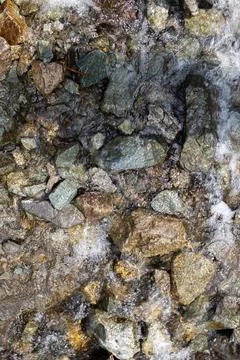 Mountain river flows fast over rocks close-up Stock Photos