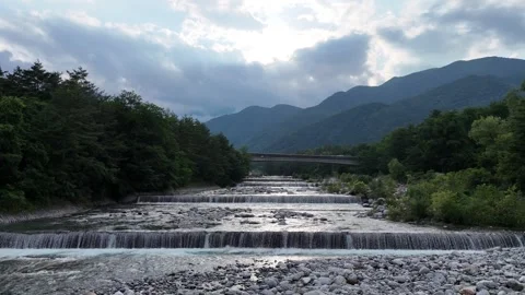 Mountain river flows gently over stones Video stock 339114224