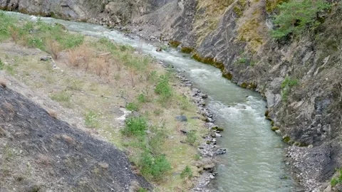 Mountain river flows into gorge 스톡 동영상 276778026