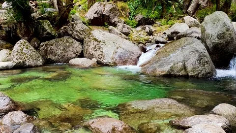Mountain river flows high in the mountains Stock Footage 304698328