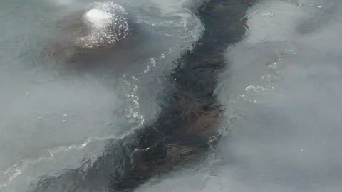 Mountain river flows near the mountains covered with ice and snow. Stock Footage 168620554