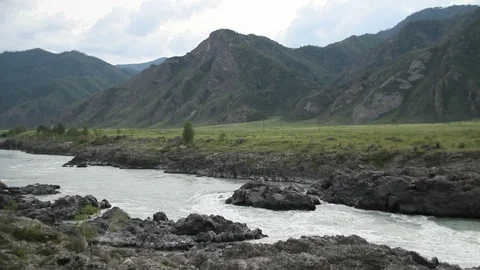 The mountain river flows in solidified, petrified lava. The mountains. 動画素材 119995782