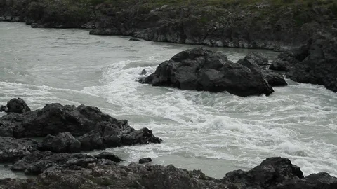 The mountain river flows in solidified, petrified lava. The mountains. 動画素材 119995795