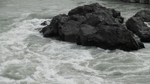 The mountain river flows in solidified, petrified lava. The mountains. Video stock 119995843