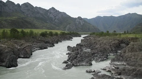 The mountain river flows in solidified, petrified lava. The mountains. Stock-Footage 119995859