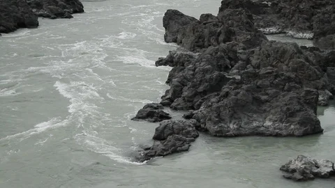 The mountain river flows in solidified, petrified lava. The mountains. 動画素材 119995862