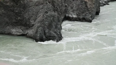 The mountain river flows in solidified, petrified lava. The mountains. 動画素材 119995863